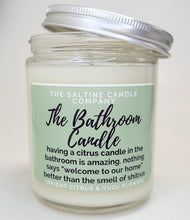 Load image into Gallery viewer, The picture is of a candle called The Bathroom Candle. It has a green label and says The Saltine Candle Company. The description says having a citrus candle in the bathroom is amazing. Nothing says welcome to our home better than the smell of shitrus. The scent says bright citrus and yuzu flower and it is a 100% soy wax funny candle