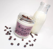 Load image into Gallery viewer, The Work From Home Candle is on a white background surrounding by fresh coffee beans and a glass container of cream.
