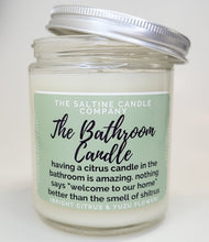 Load image into Gallery viewer, The picture is of a candle called The Bathroom Candle. It has a green label and says The Saltine Candle Company. The description says having a citrus candle in the bathroom is amazing. Nothing says welcome to our home better than the smell of shitrus.  The scent says bright citrus and yuzu flower and it is a 100% soy wax funny candle
