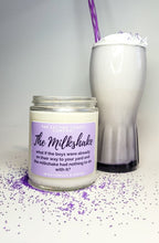 Load image into Gallery viewer, The Milkshake candle has a pastel purple label and is standing beside a milkshake with whipped cream and a purple straw. There is matching purple sprinkles surrounding everything.
